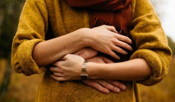 Support from the arms of strangers.